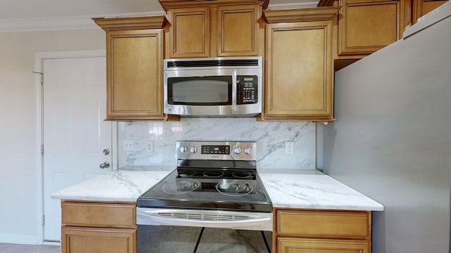 kitchen featuring crown molding, appliances with stainless steel finishes, and decorative backsplash