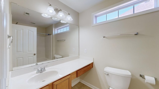 bathroom with vanity, tile patterned floors, and toilet