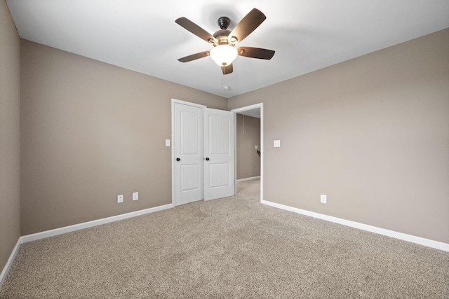 unfurnished bedroom featuring ceiling fan and carpet floors