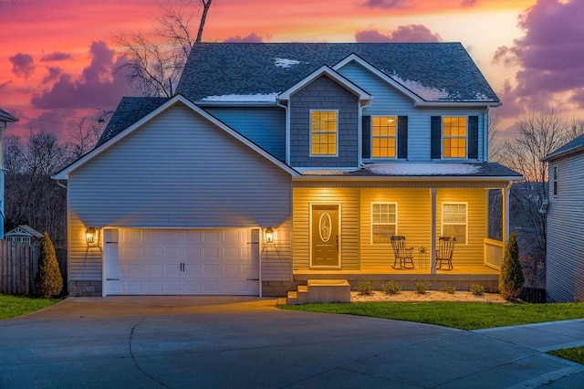 view of front of property featuring a porch and a garage