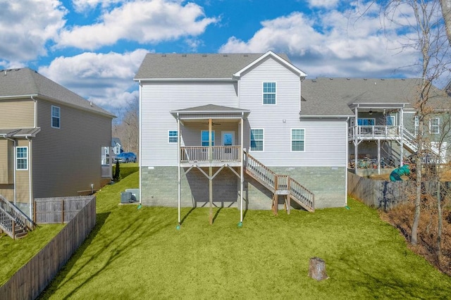 rear view of property featuring a lawn