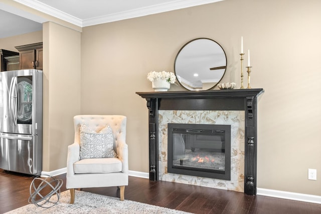 sitting room with crown molding and dark hardwood / wood-style floors