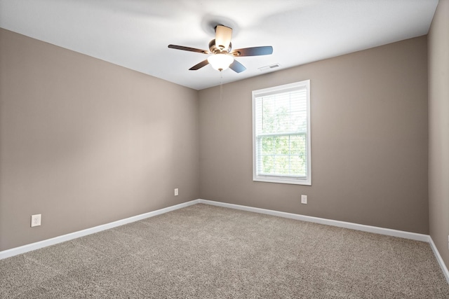 spare room featuring carpet floors and ceiling fan