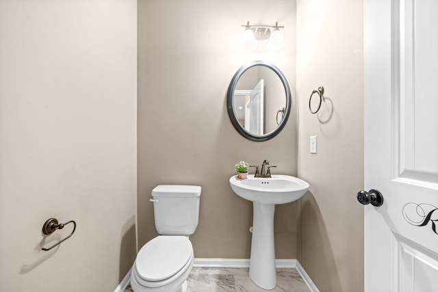 bathroom featuring sink and toilet