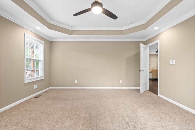 unfurnished bedroom with crown molding, ceiling fan, and a raised ceiling