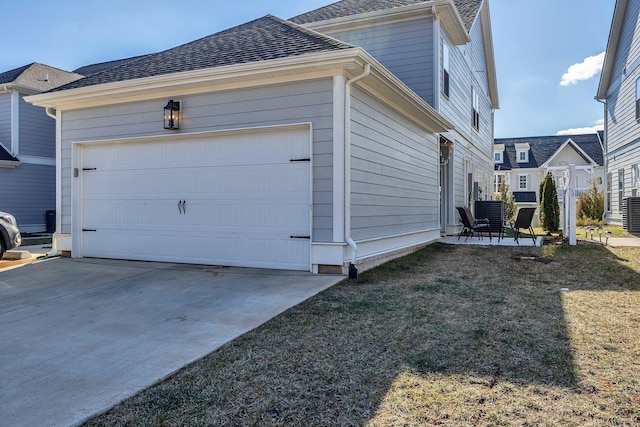 view of property exterior with a garage and a yard