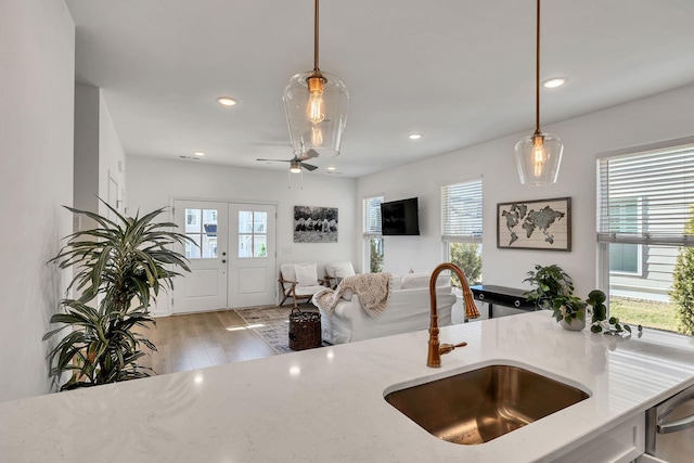 kitchen with sink, hanging light fixtures, and a wealth of natural light