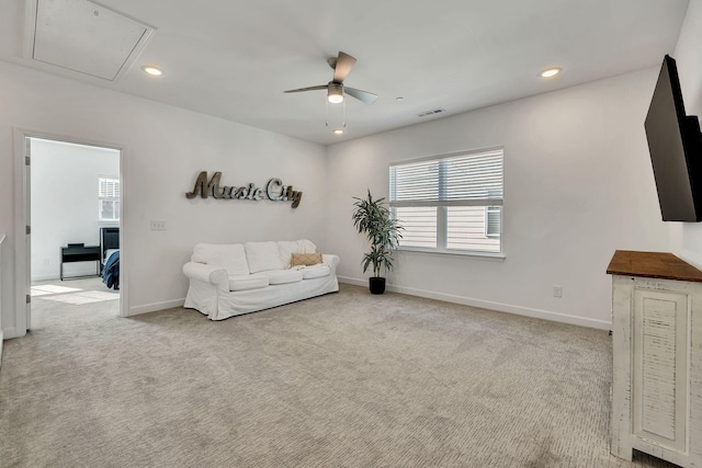 living room featuring light carpet and ceiling fan