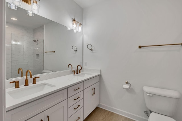 bathroom with vanity, wood-type flooring, a shower with door, and toilet