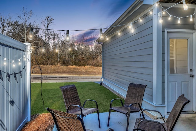 patio terrace at dusk with a lawn