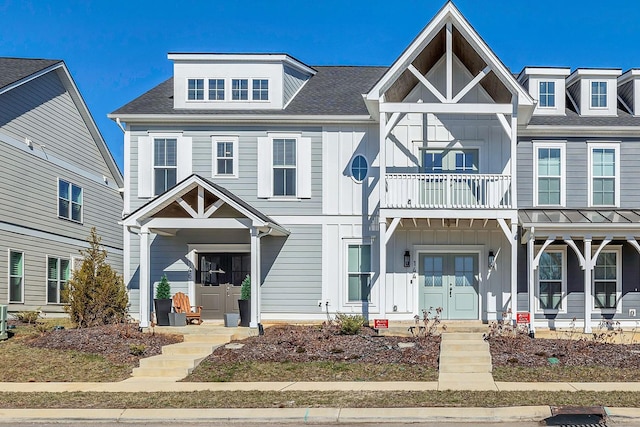 view of front of home with a balcony and central AC unit