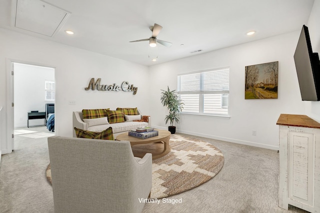 carpeted living room with ceiling fan