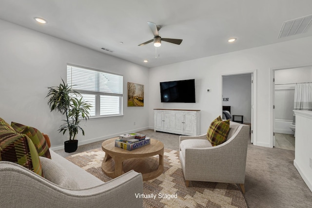 living room with ceiling fan and light carpet