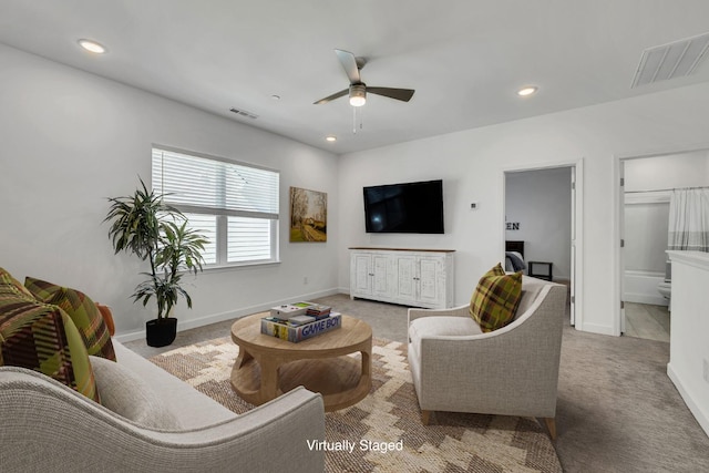 carpeted living room with ceiling fan