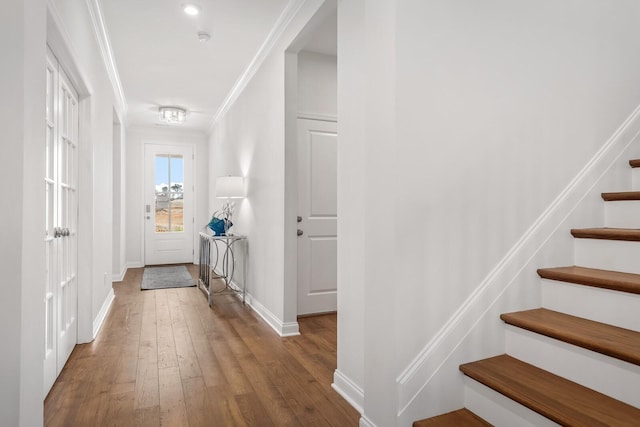 interior space with wood-type flooring and ornamental molding