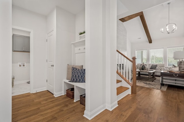 interior space featuring hardwood / wood-style flooring, a chandelier, and lofted ceiling with beams