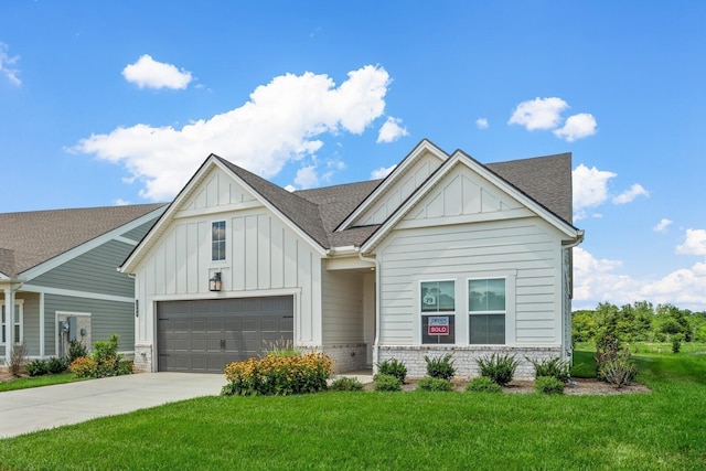 view of front of property with a garage and a front lawn