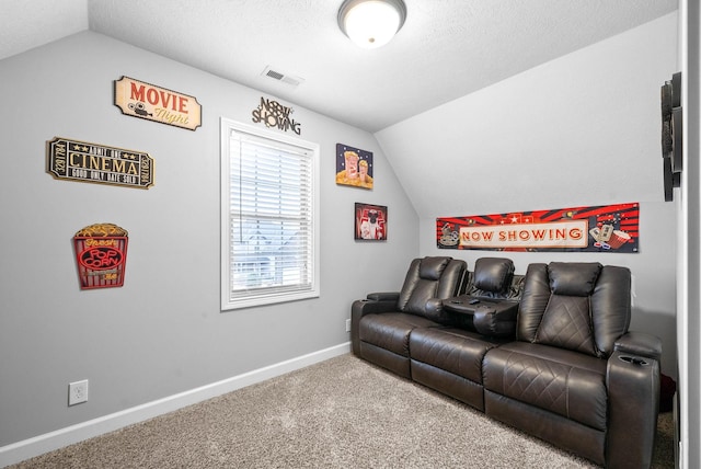 home theater room with carpet floors and vaulted ceiling