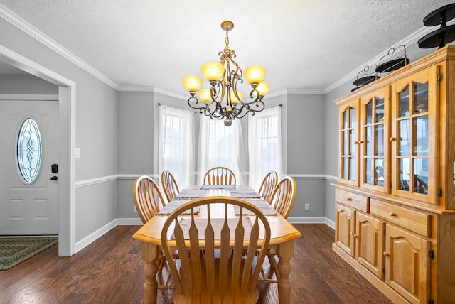 dining area with crown molding, dark wood-type flooring, a textured ceiling, and a notable chandelier