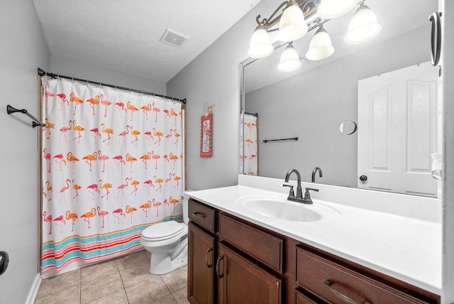 bathroom with a shower with shower curtain, vanity, a textured ceiling, tile patterned floors, and toilet