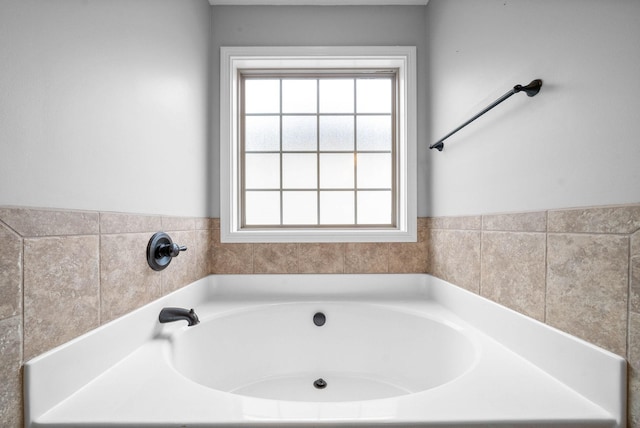 bathroom featuring a tub to relax in