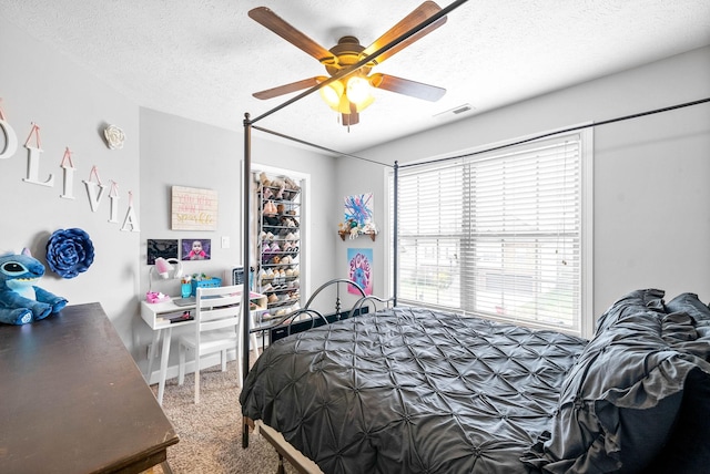 bedroom featuring a textured ceiling and ceiling fan