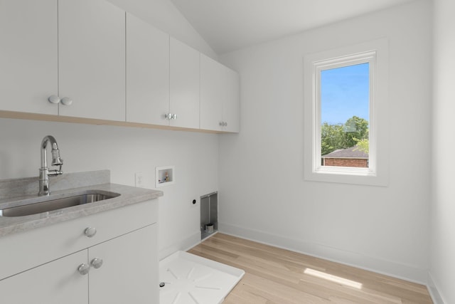 laundry area with sink, electric dryer hookup, cabinets, washer hookup, and light wood-type flooring