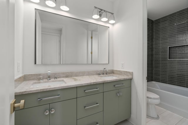 full bathroom featuring vanity, tiled shower / bath combo, tile patterned floors, and toilet