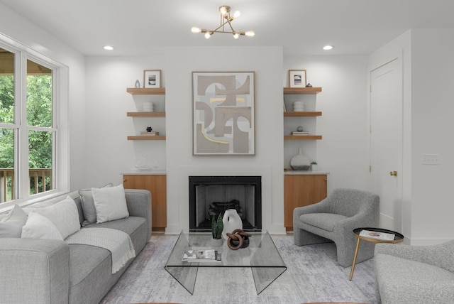 living room featuring an inviting chandelier and light hardwood / wood-style flooring