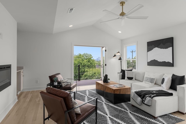 living room with vaulted ceiling, ceiling fan, and light hardwood / wood-style floors