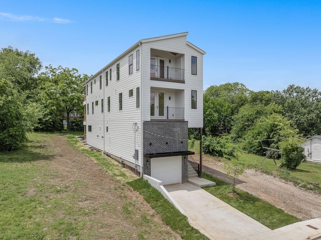 view of front facade with a balcony and a garage