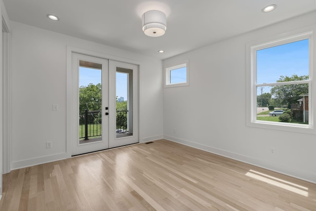 unfurnished room featuring light wood-type flooring and french doors