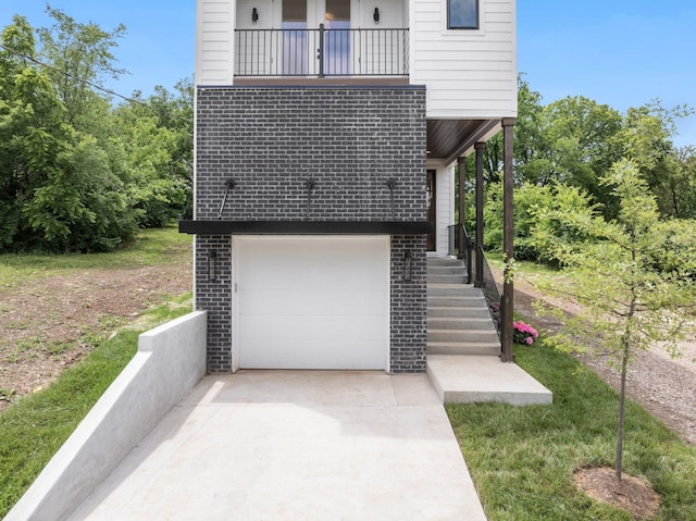 view of home's exterior with a balcony and a garage