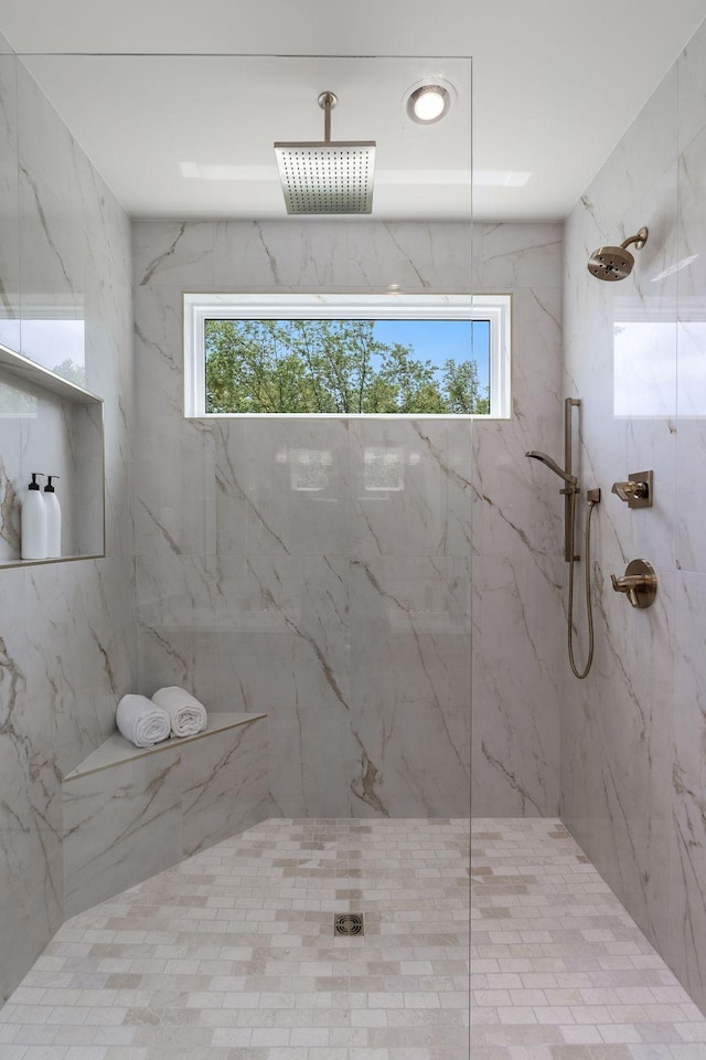 bathroom with a healthy amount of sunlight and a tile shower