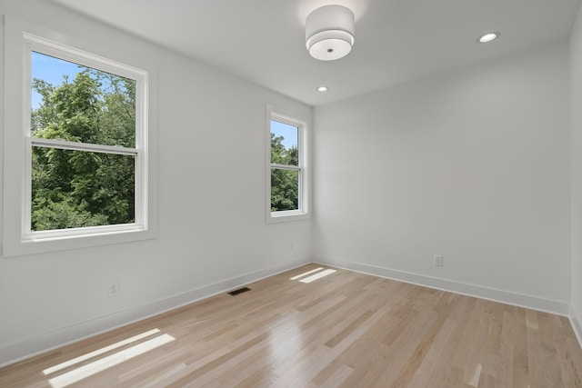 spare room with light hardwood / wood-style floors