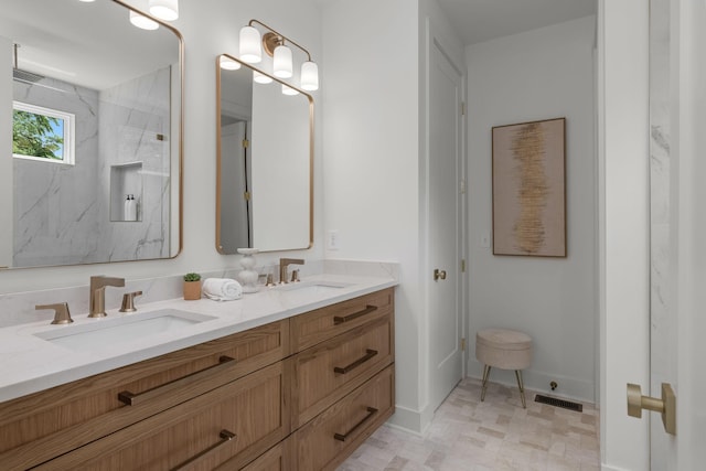 bathroom featuring vanity and a shower