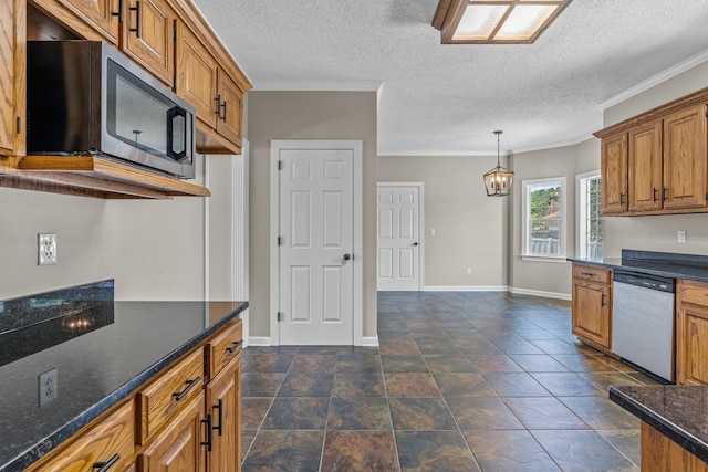 kitchen featuring a textured ceiling, dark stone counters, ornamental molding, pendant lighting, and stainless steel appliances