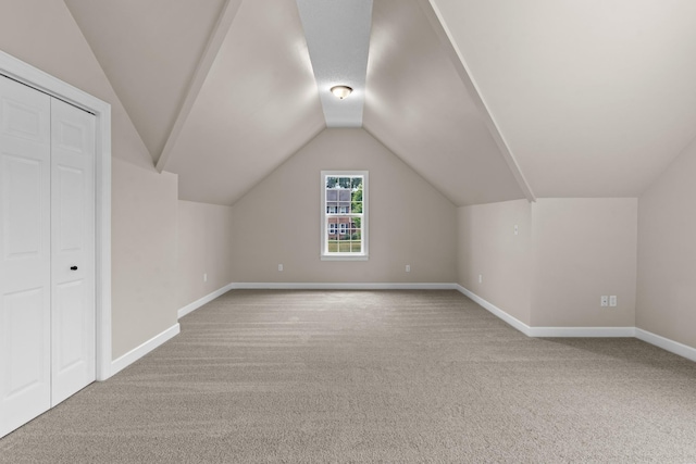 bonus room featuring vaulted ceiling and carpet