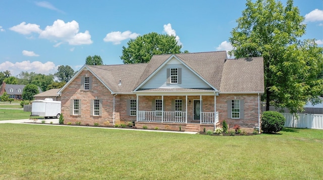 view of front of home with a porch and a front lawn