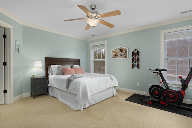 bedroom featuring light carpet, ornamental molding, and ceiling fan