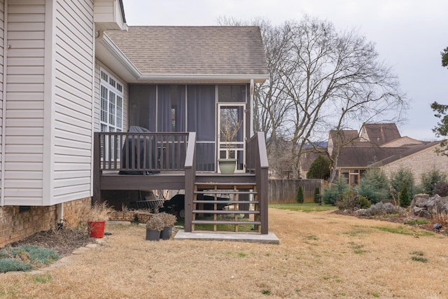 back of house with a sunroom and a yard