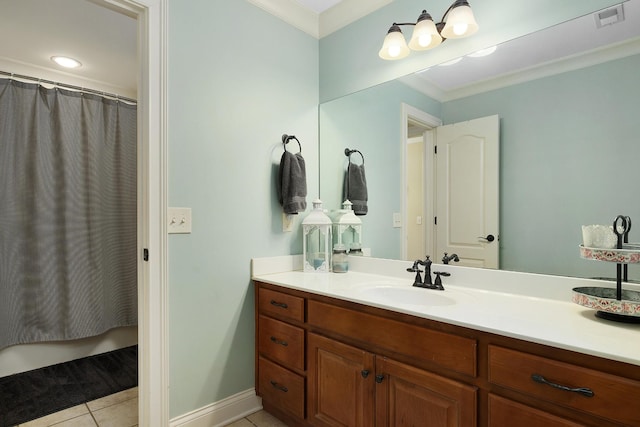 bathroom with tile patterned flooring, crown molding, and vanity