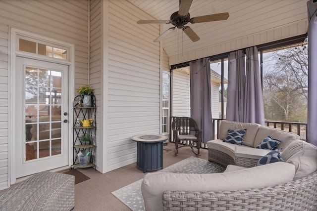 sunroom featuring vaulted ceiling and ceiling fan