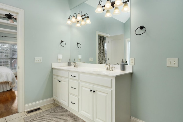 bathroom featuring vaulted ceiling, ceiling fan, vanity, and tile patterned flooring