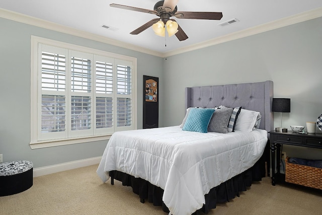 carpeted bedroom featuring crown molding and ceiling fan