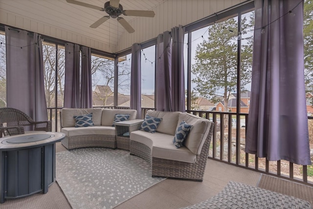 sunroom / solarium featuring ceiling fan, a healthy amount of sunlight, and vaulted ceiling