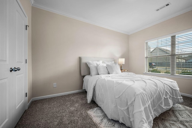 bedroom featuring dark colored carpet and ornamental molding