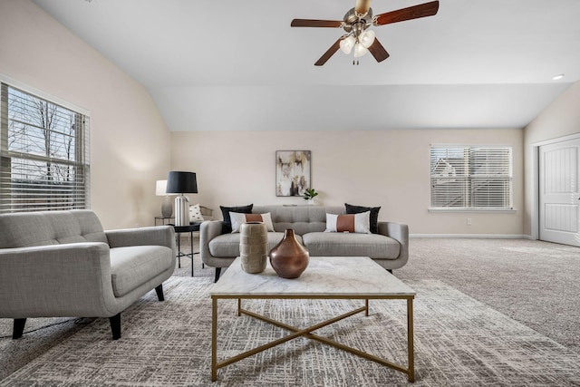 carpeted living room with lofted ceiling, a wealth of natural light, and ceiling fan