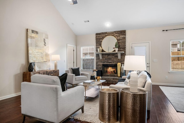 living room with a fireplace, dark hardwood / wood-style flooring, and high vaulted ceiling