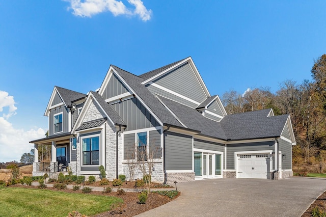 craftsman house with a garage, covered porch, and a front lawn